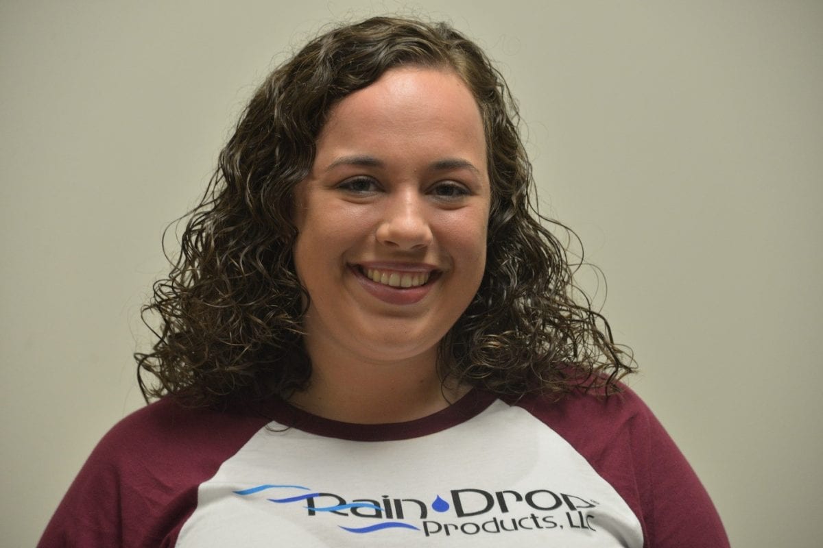 Jaylin Beebe poses with her Rain Drop Products, LLC shirt where she recently got a full time position.