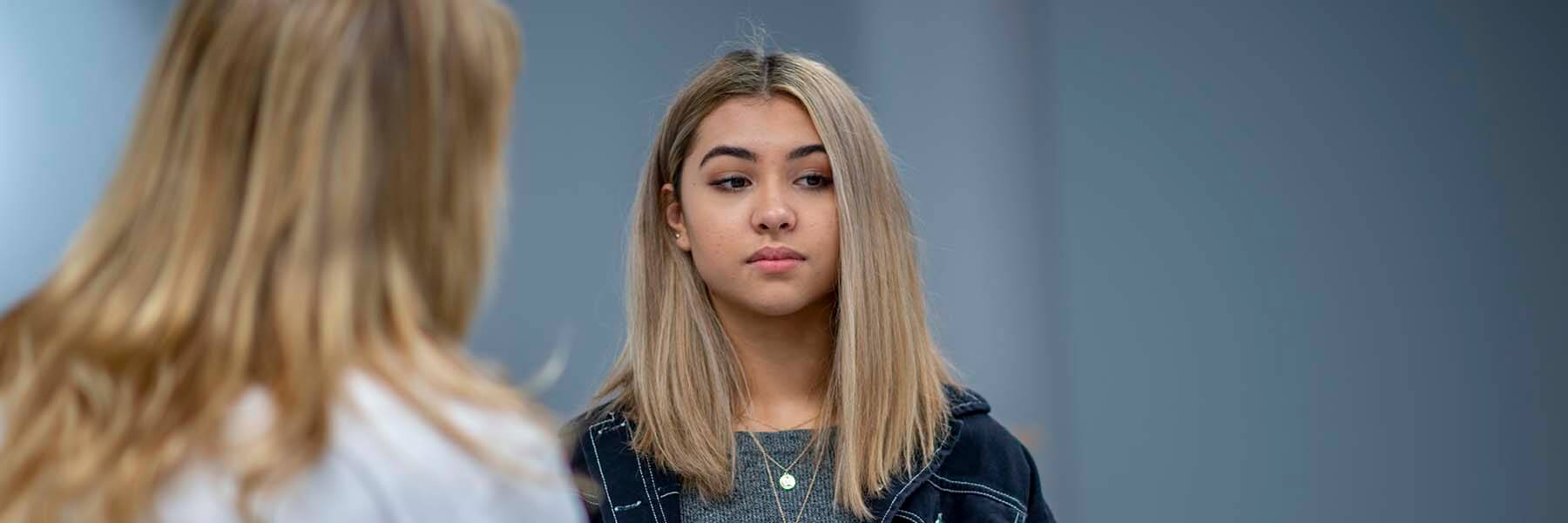 Young woman talking to a counselor.