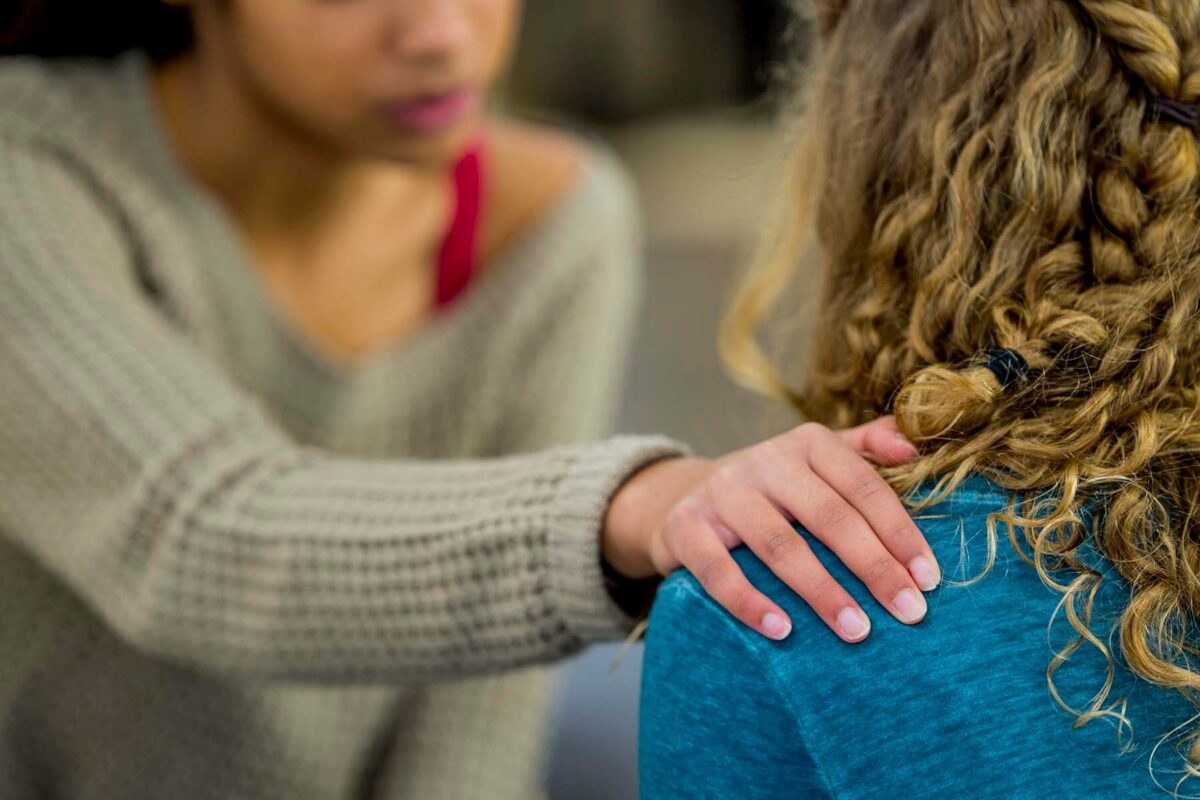 Young woman consoling her friend.