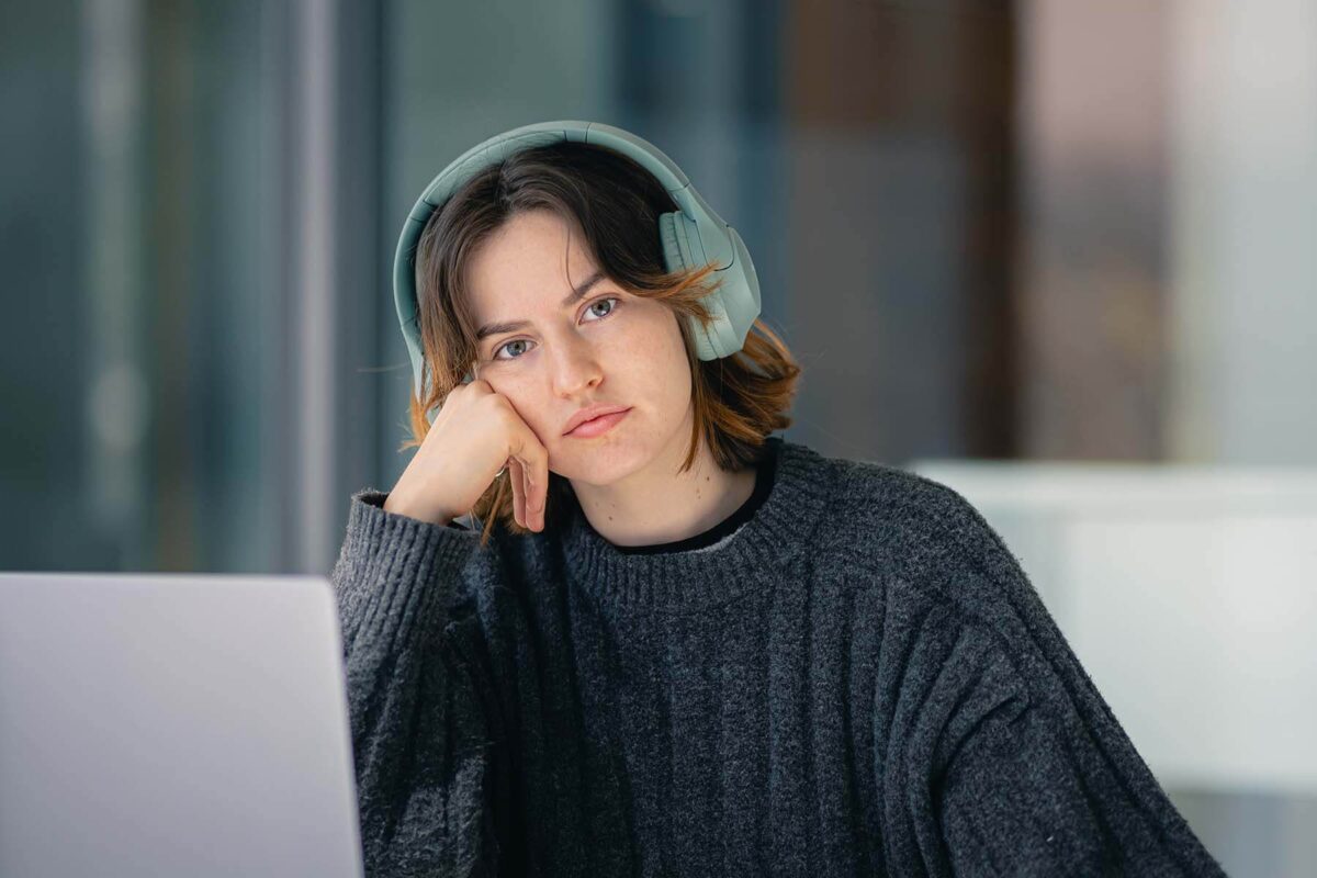 Sad person with headphones on.