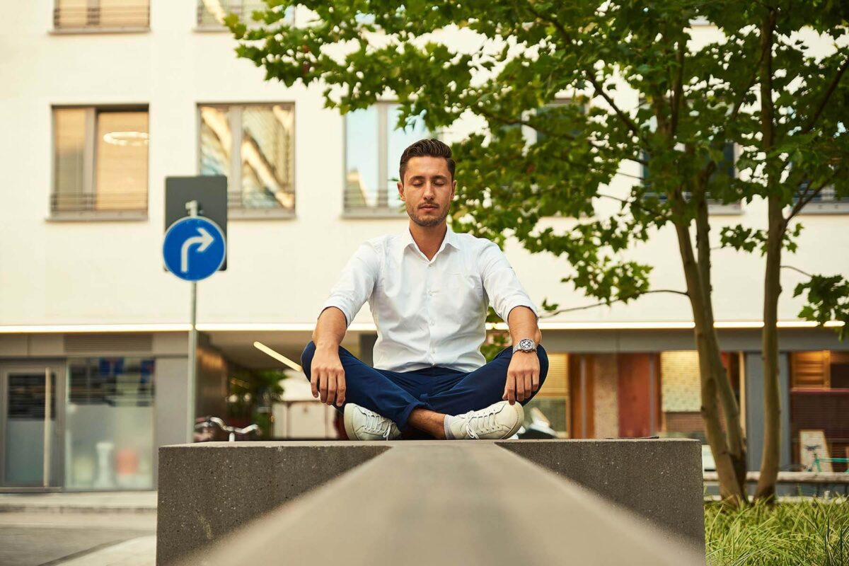 Young man sitting with crossed legs.