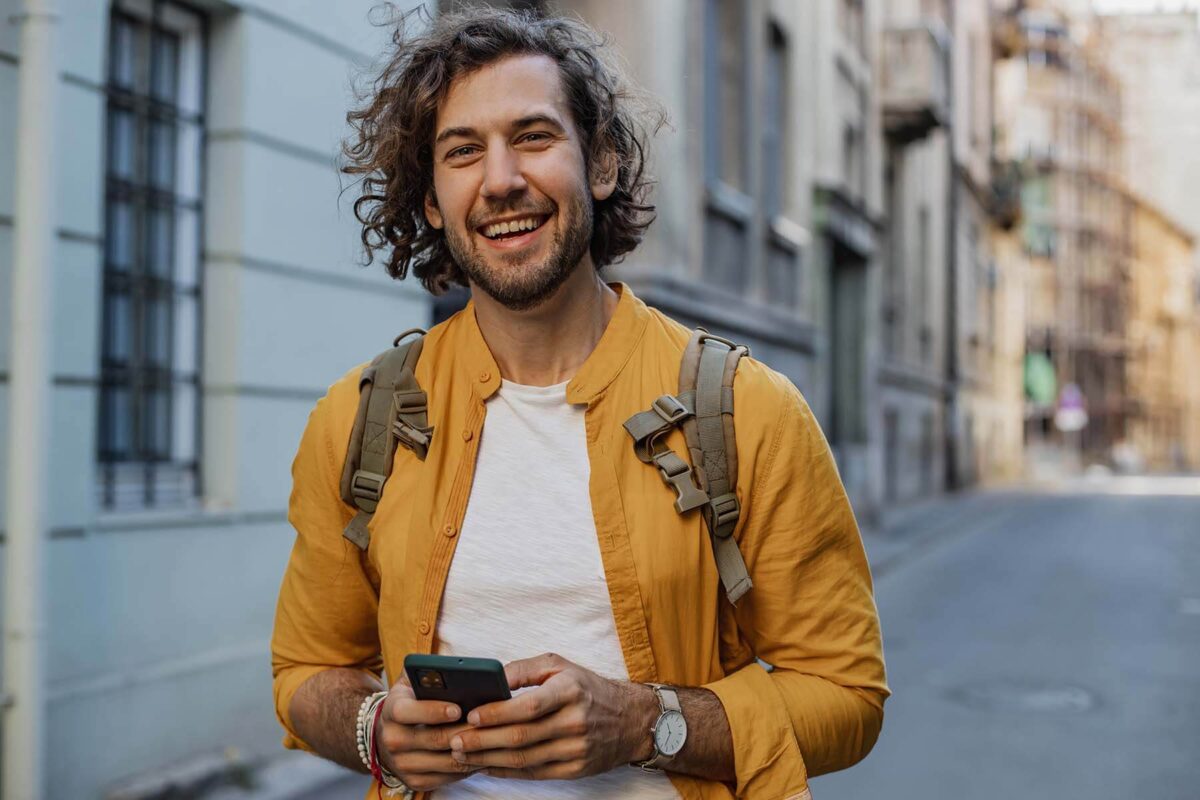 Happy young man walking down the street