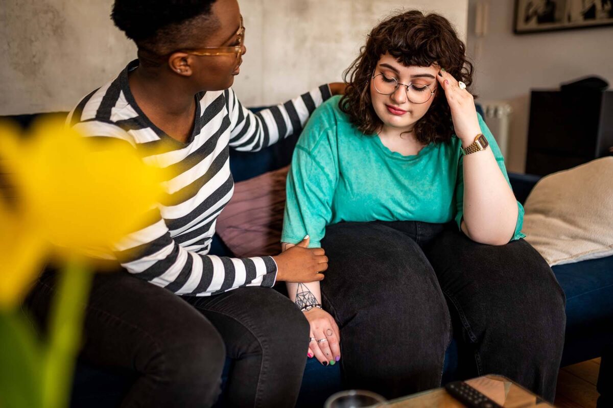 Young woman comforts her friend