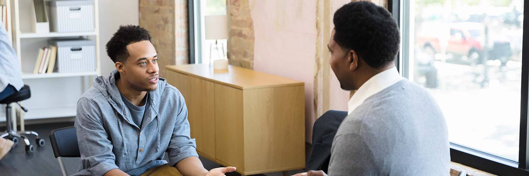 Young man talking to his counselor