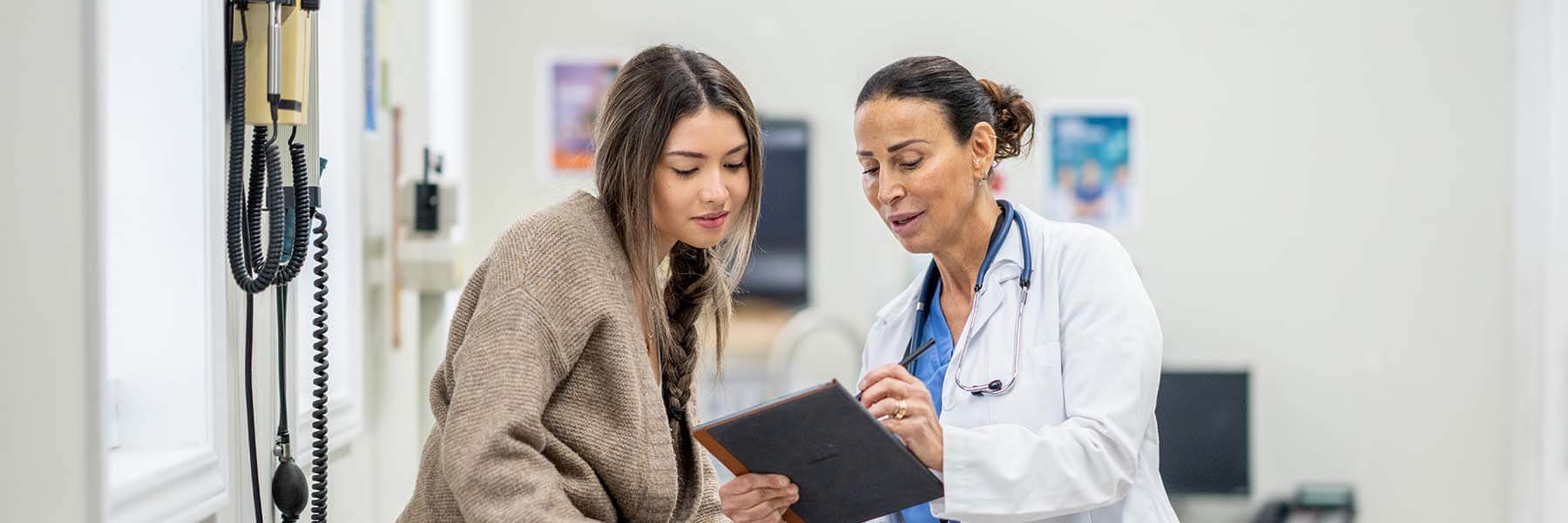 Young woman talking with her doctor