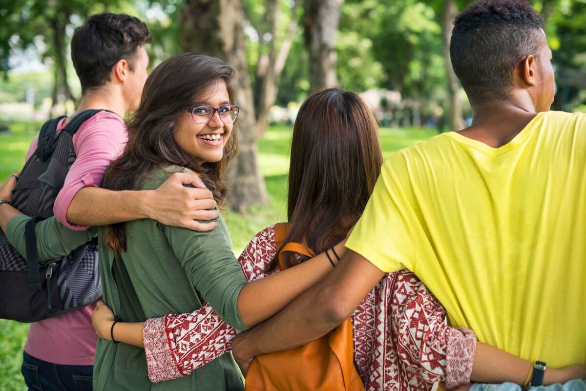 Group of friends linking arms