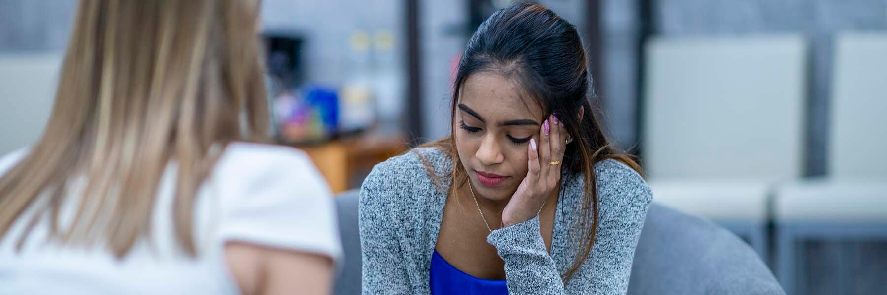 Sad woman talking to counselor