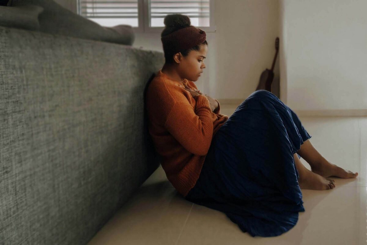 Sad woman sitting on the floor