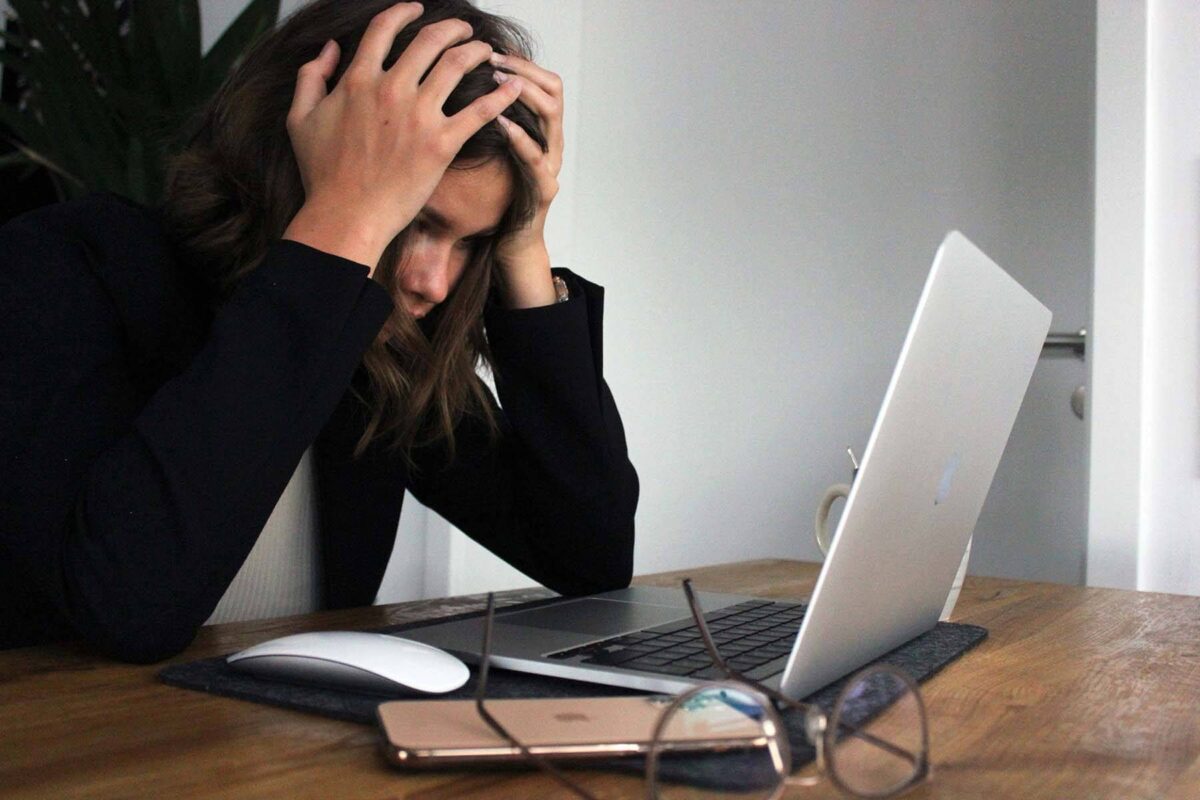 Frustrated woman looking at her laptop