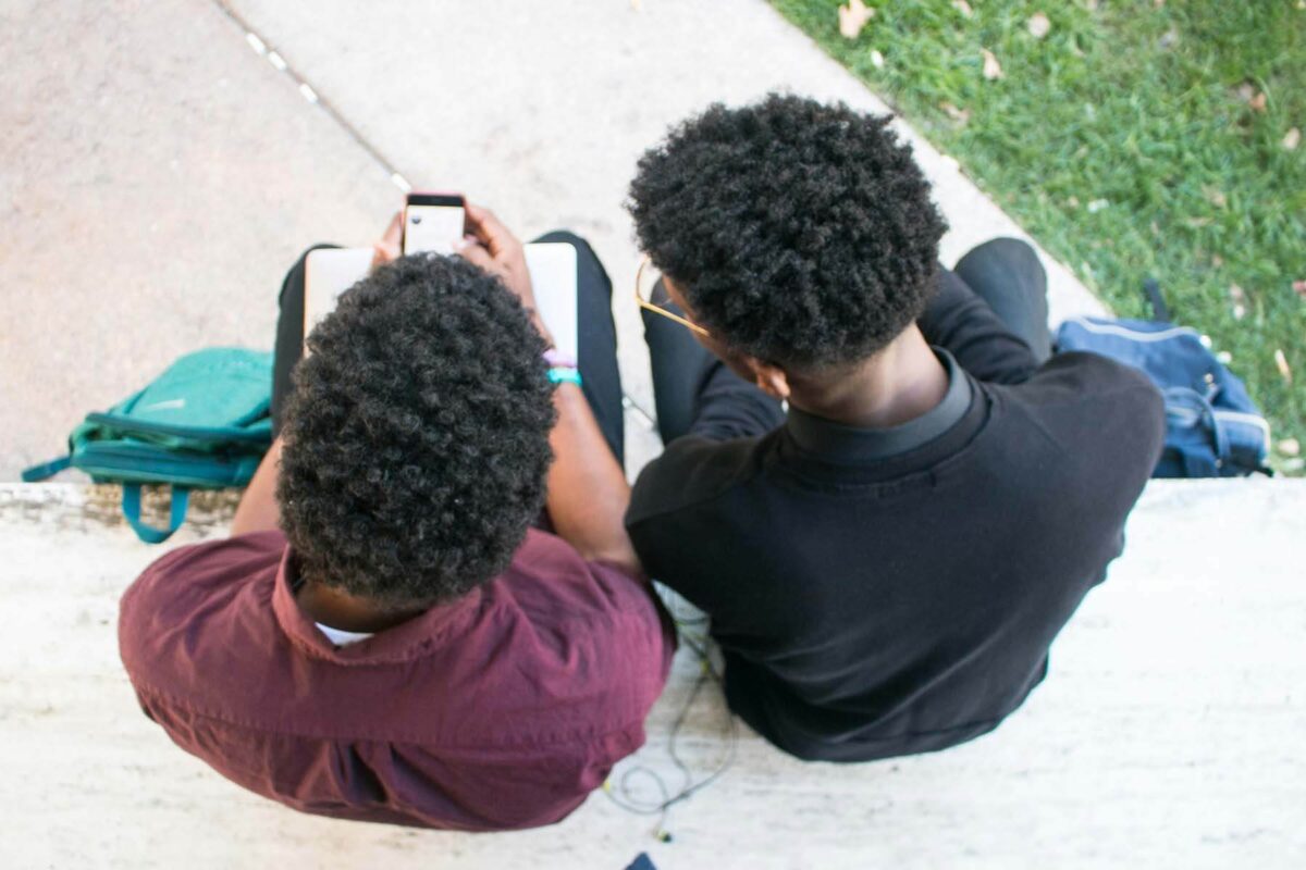 Two friends looking at a phone
