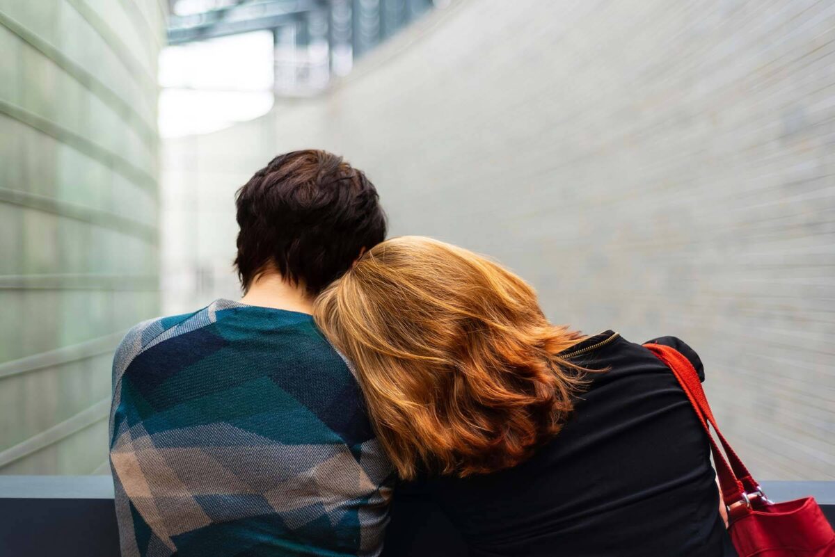 Woman leaning her head on her friend's shoulder