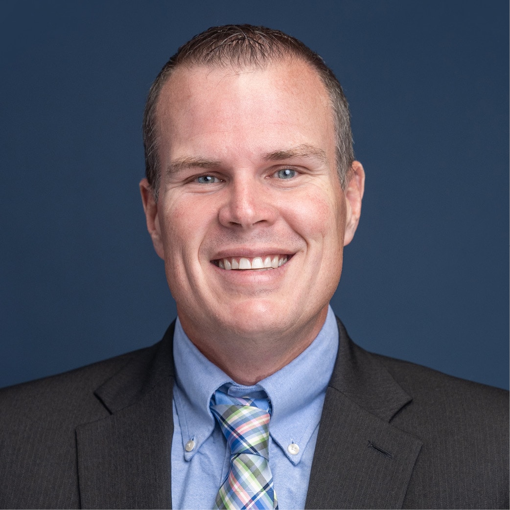 chris hiner in s suit smiling