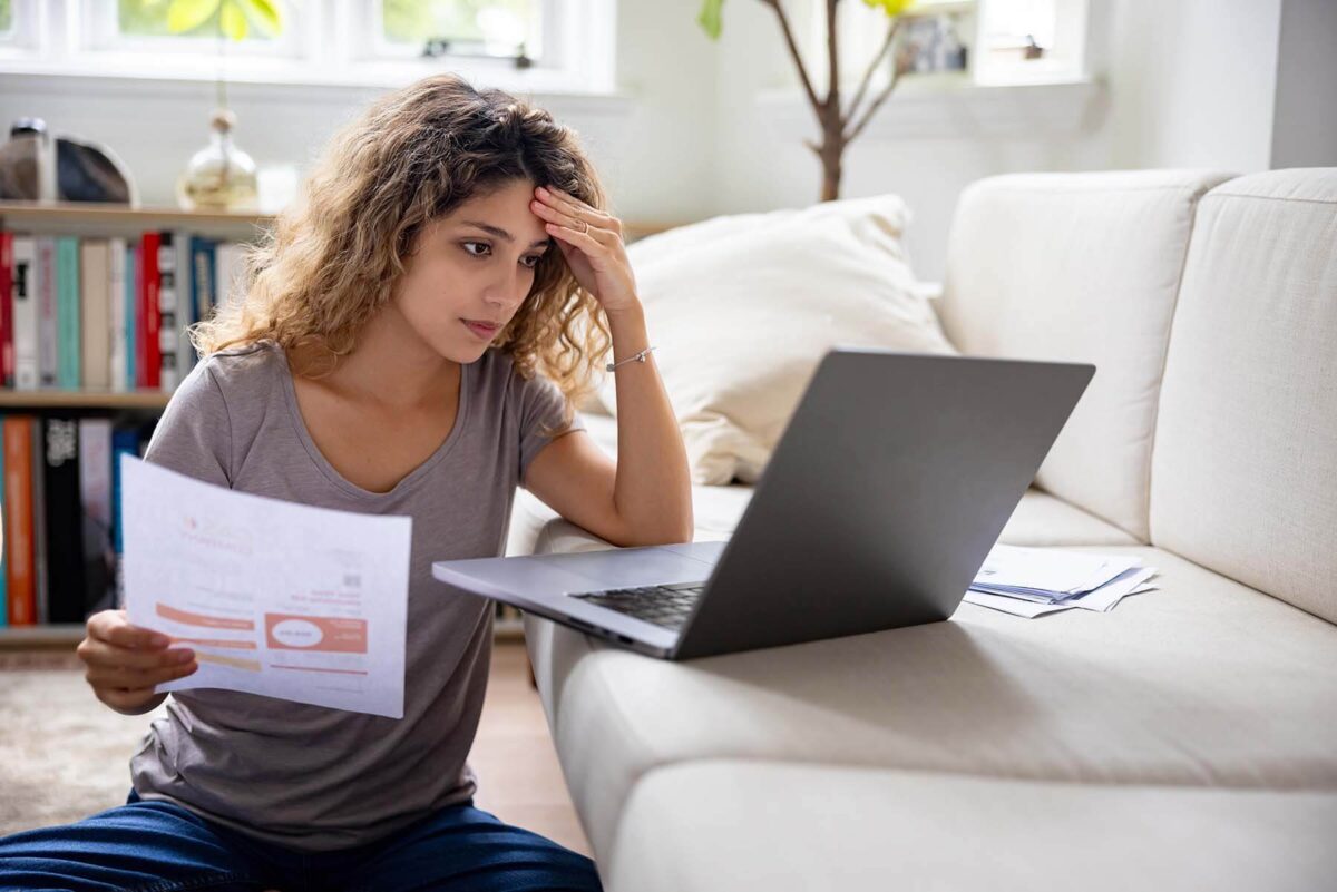 Worried woman checking utility bill