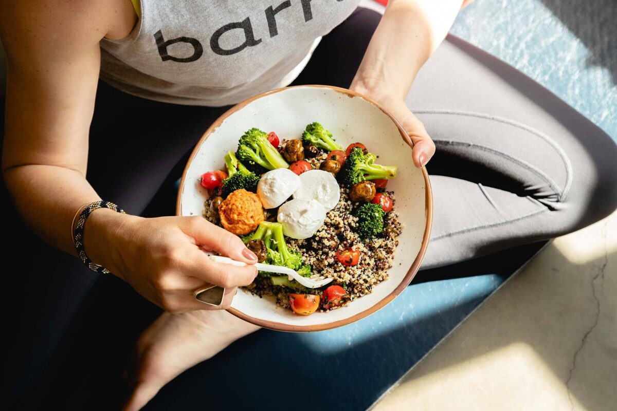 Woman eating a bowl of healthy food