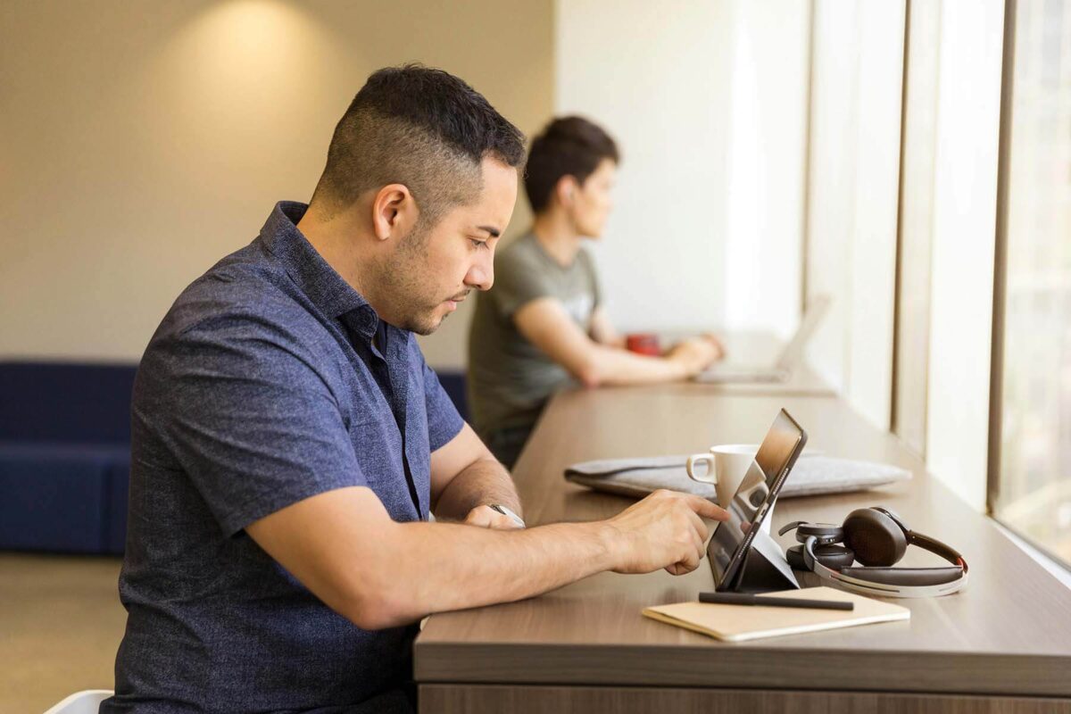 Man using a tablet at a desk