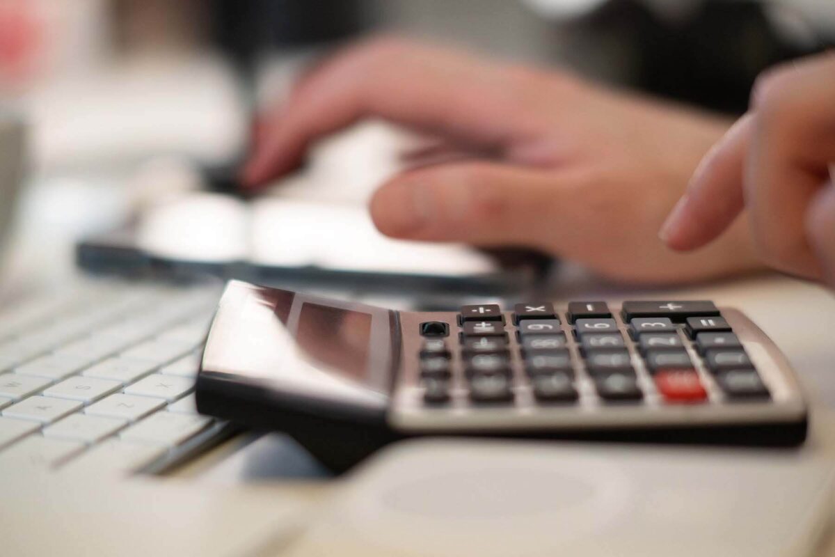 Closeup of person using a calculator