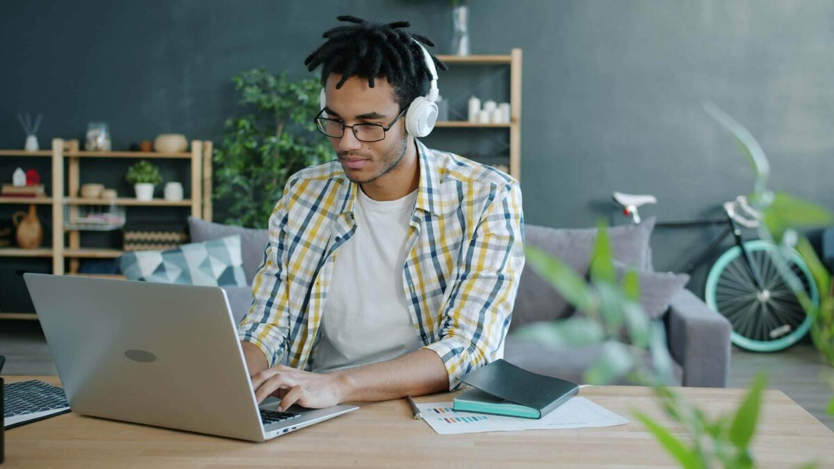 Young man with headphones working on a laptop